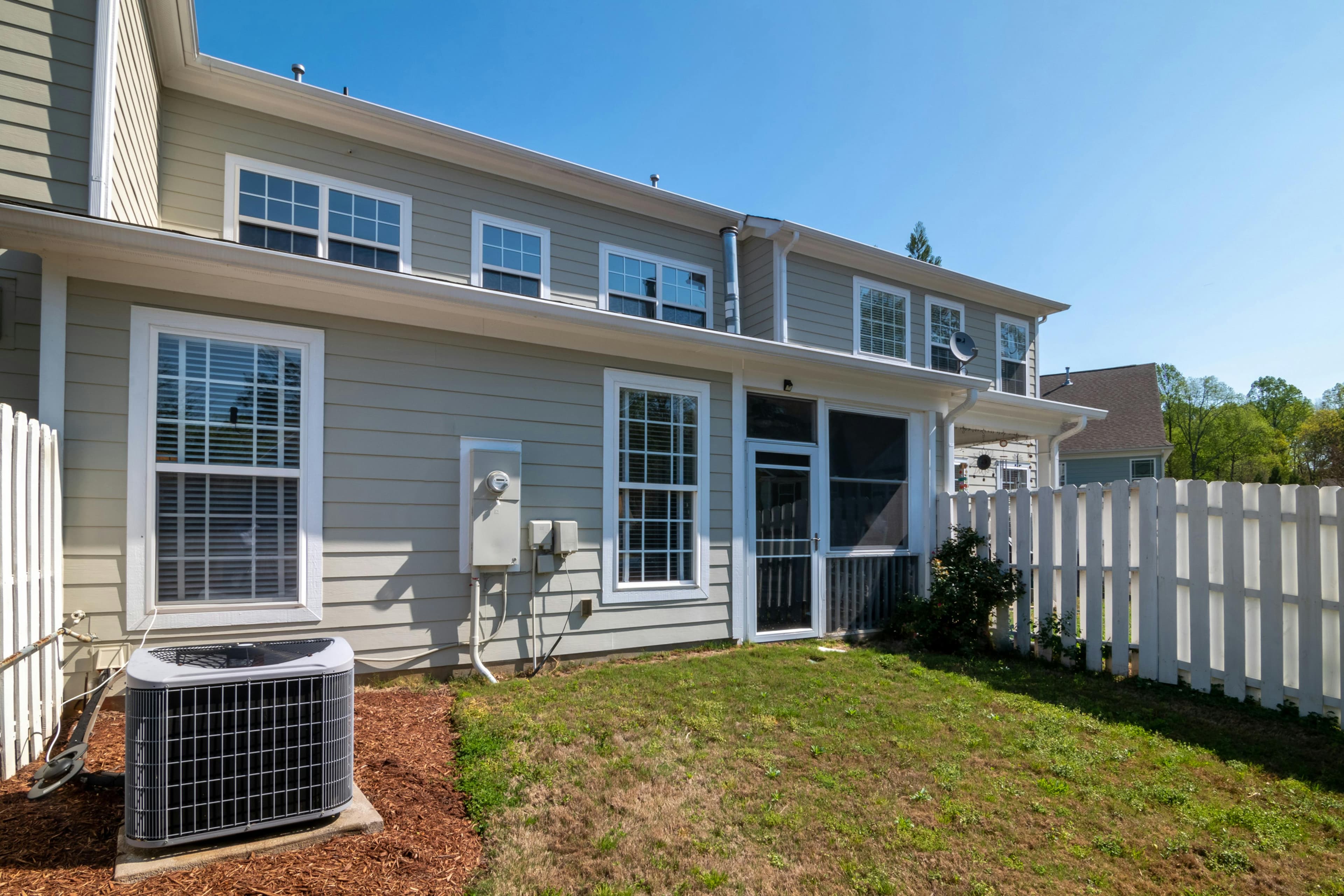Residential home exterior with AC unit in a Mansfield TX backyard